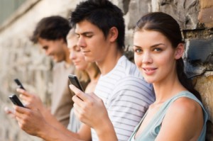 Closeup portrait of young men and women holding cellphone