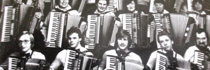 Black-and-white vintage cartoon of a group playing accordions, posed together with multiple musicians holding striped instruments.