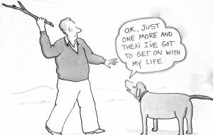 A man holding a stick while speaking to a dog that is looking up at him.