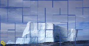 A large iceberg floating in the ocean under a cloudy sky with geometric overlay.