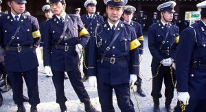 Group of Japanese police officers in uniform standing together at an event.