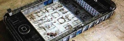 Aerial view of a large prison facility with multiple sections and a surrounding wall.